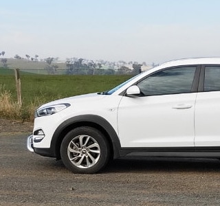 Drive Less Pay Less . Couple and Car Image 