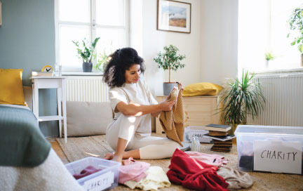 Woman sorting out clothes for charity